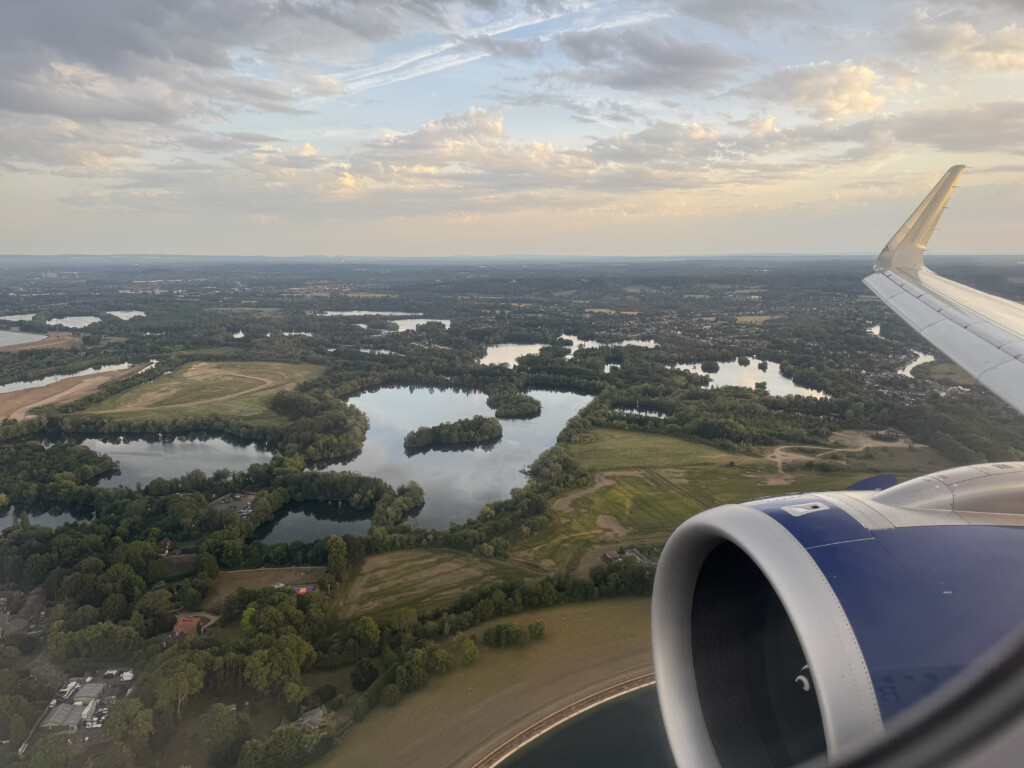 an airplane wing and a body of water