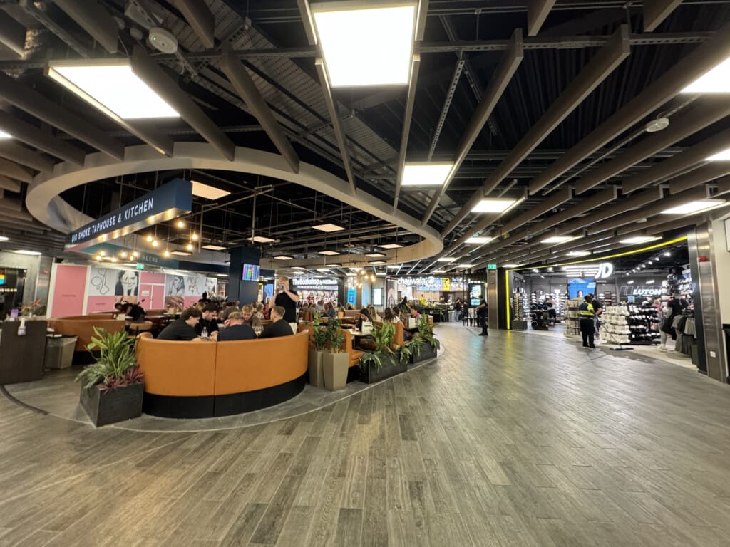 a large room with a large group of people sitting around a table