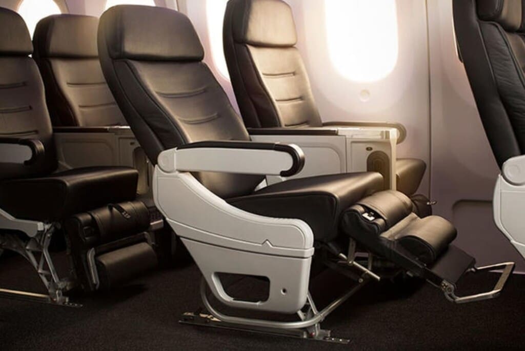 a row of black and white seats in an airplane