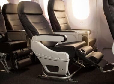 a row of black and white seats in an airplane