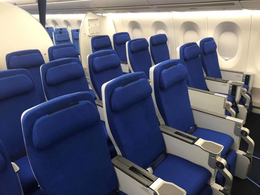 a row of blue seats in an airplane