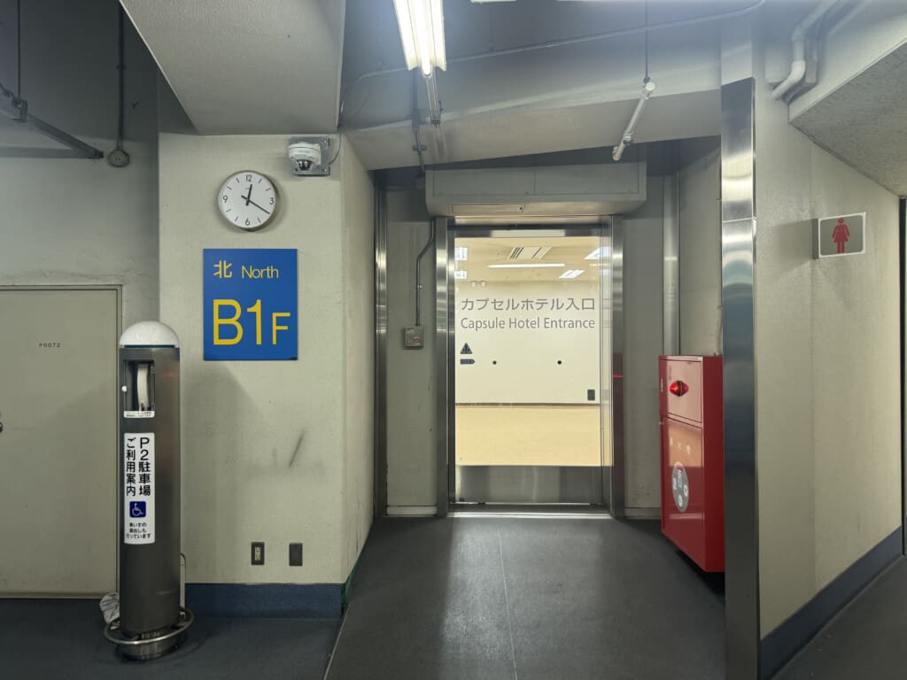 a hallway with a door and a clock