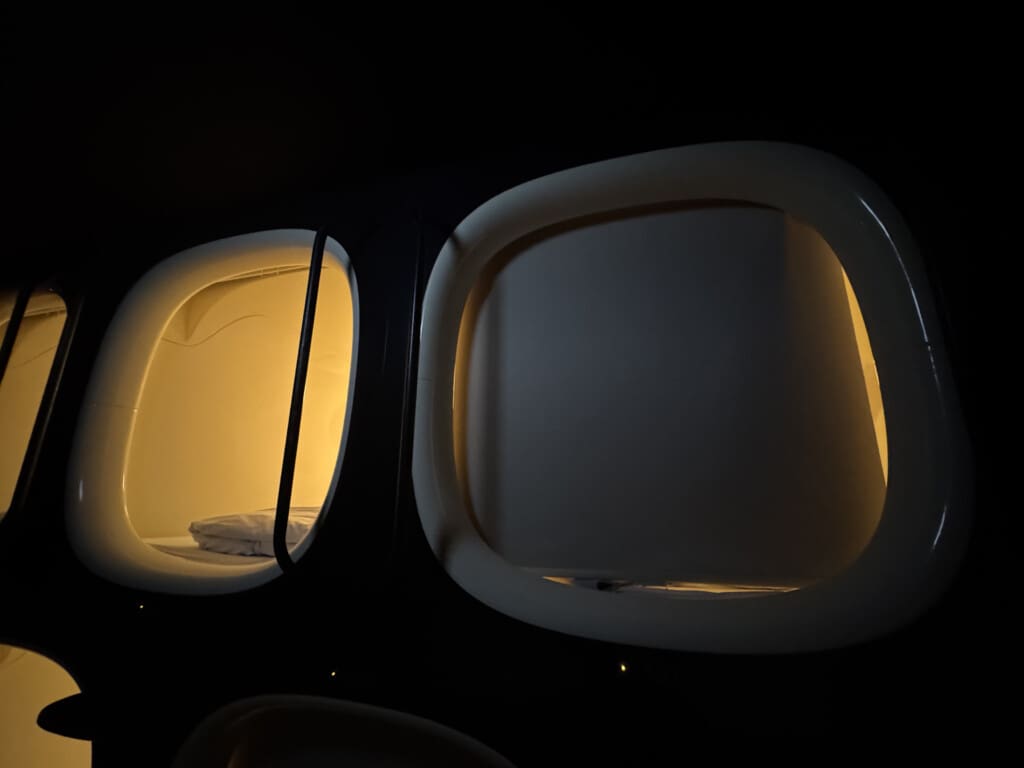 a two oval shaped windows with a light in the middle
