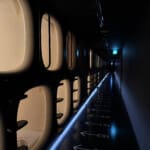 a row of toilets in a dark hallway