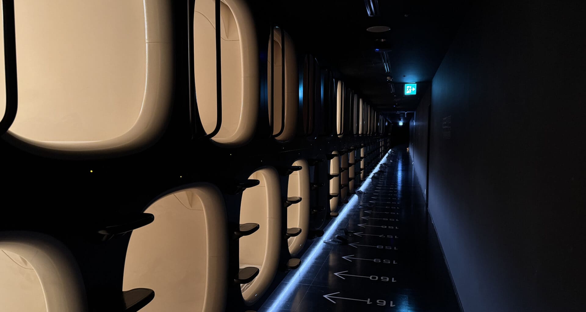 a row of toilets in a dark hallway