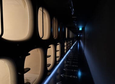 a row of toilets in a dark hallway