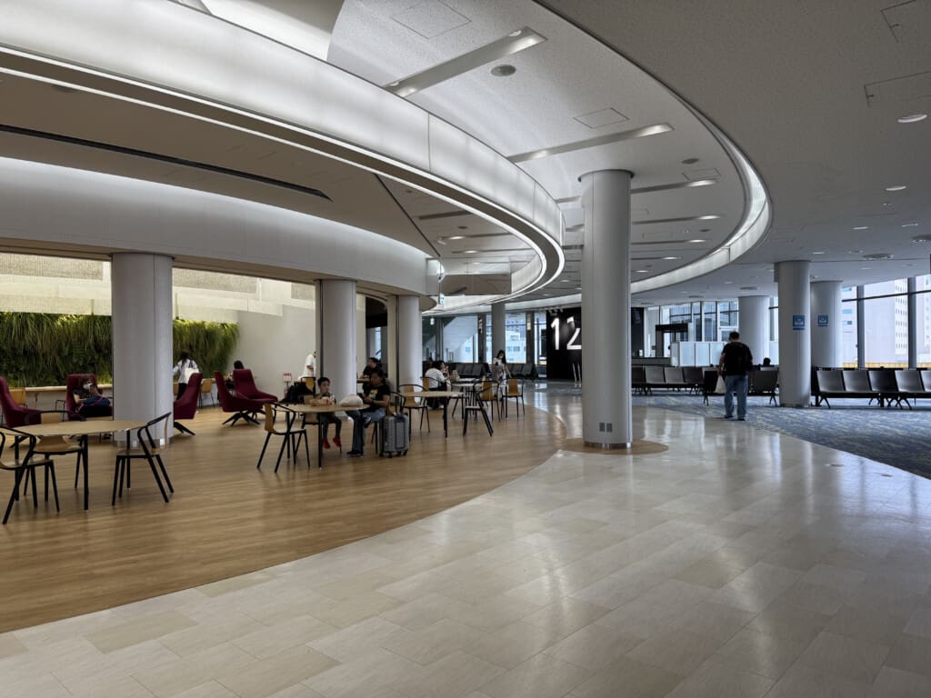 a large room with white columns and tables and chairs