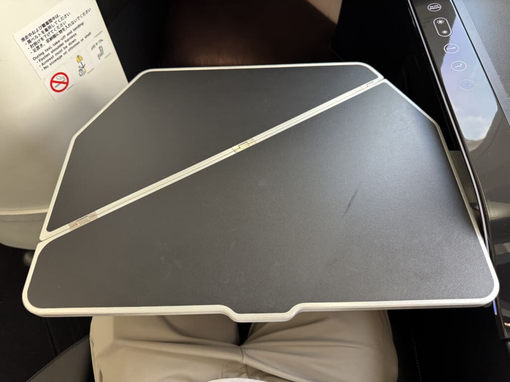 a black and white rectangular object on a person's lap