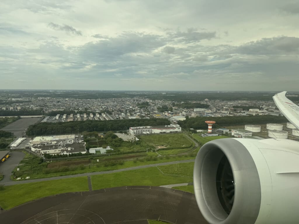an airplane wing and a city