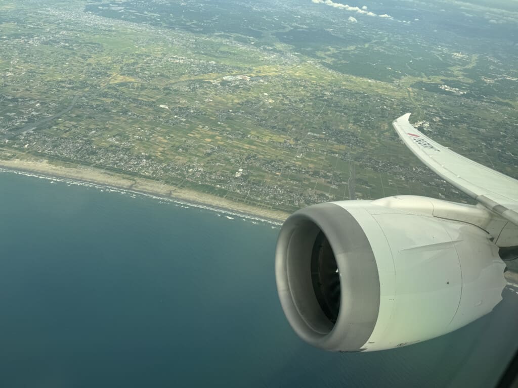 an airplane wing and wing of an airplane flying over land