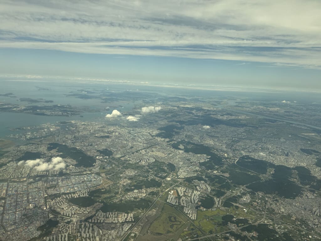 aerial view of a city and water from an airplane