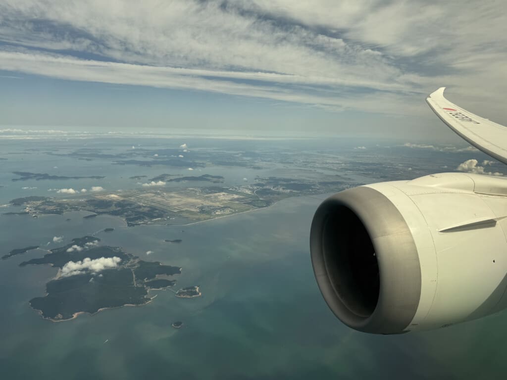 an airplane wing and a body of water