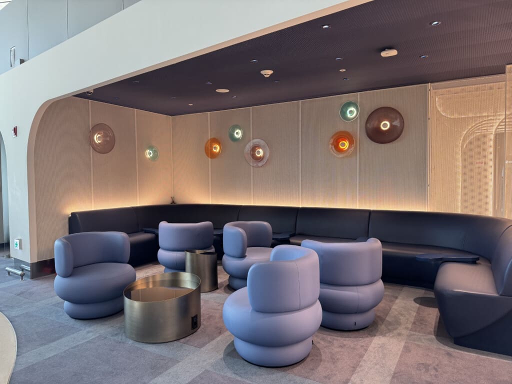 a room with a couch and chairs