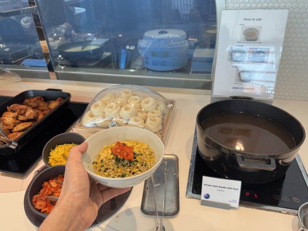 a hand holding a bowl of food