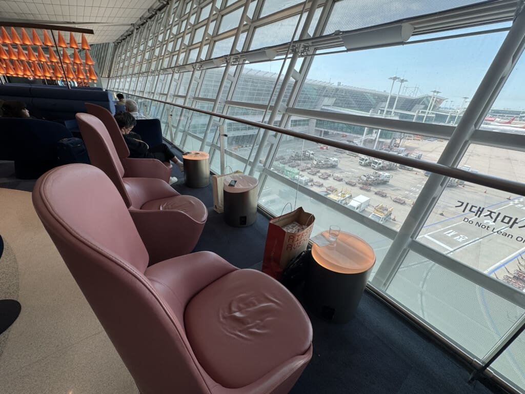 a room with chairs and a large window