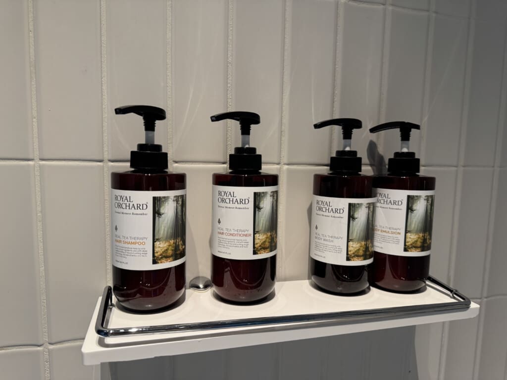 a group of bottles of liquid soap on a shelf