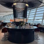 a bar with a large chandelier and a large glass ceiling