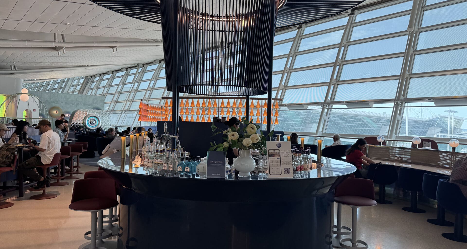 a bar with a large chandelier and a large glass ceiling