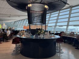 a bar with a large chandelier and a large glass ceiling