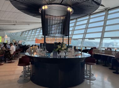 a bar with a large chandelier and a large glass ceiling