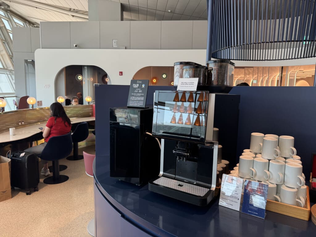 a coffee machine and cups on a table