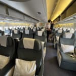 a couple of people standing in an airplane
