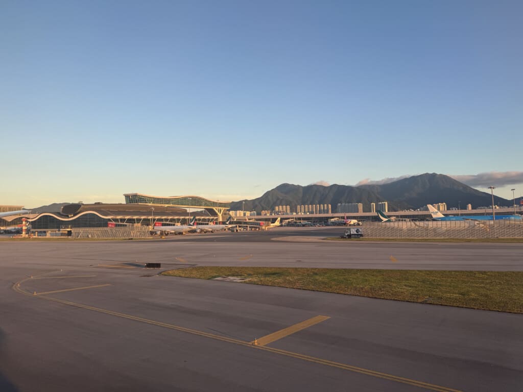an airport with a runway and buildings in the background