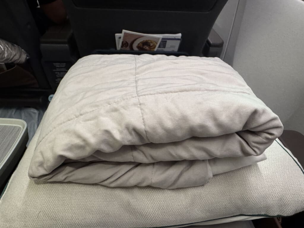 a stack of blankets on a chair
