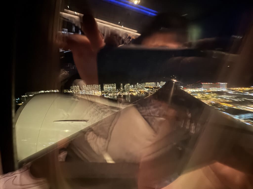 a person holding a phone in front of a window