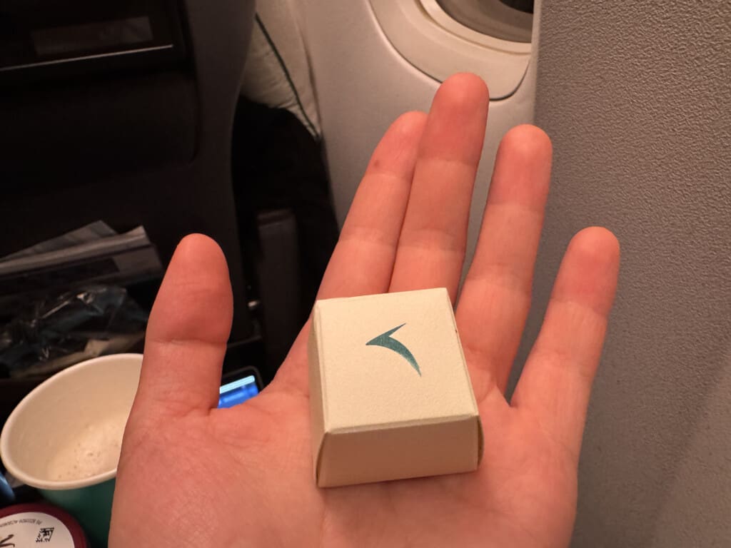 a hand holding a small box