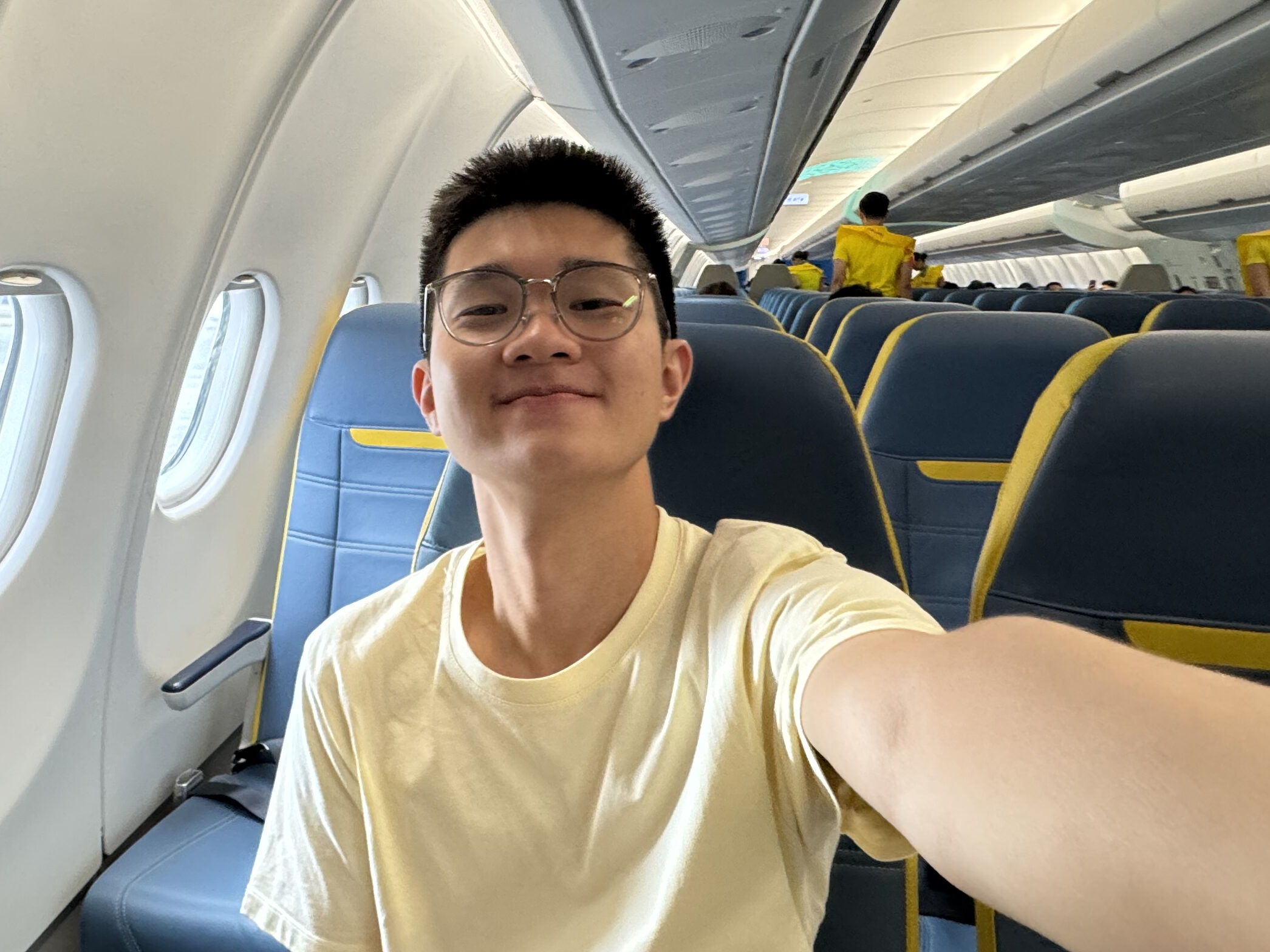 a man taking a selfie in an airplane