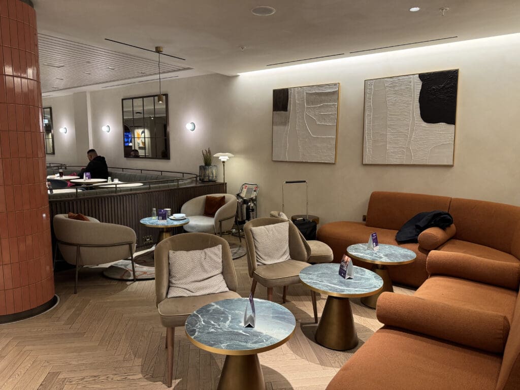 a room with a couch and chairs