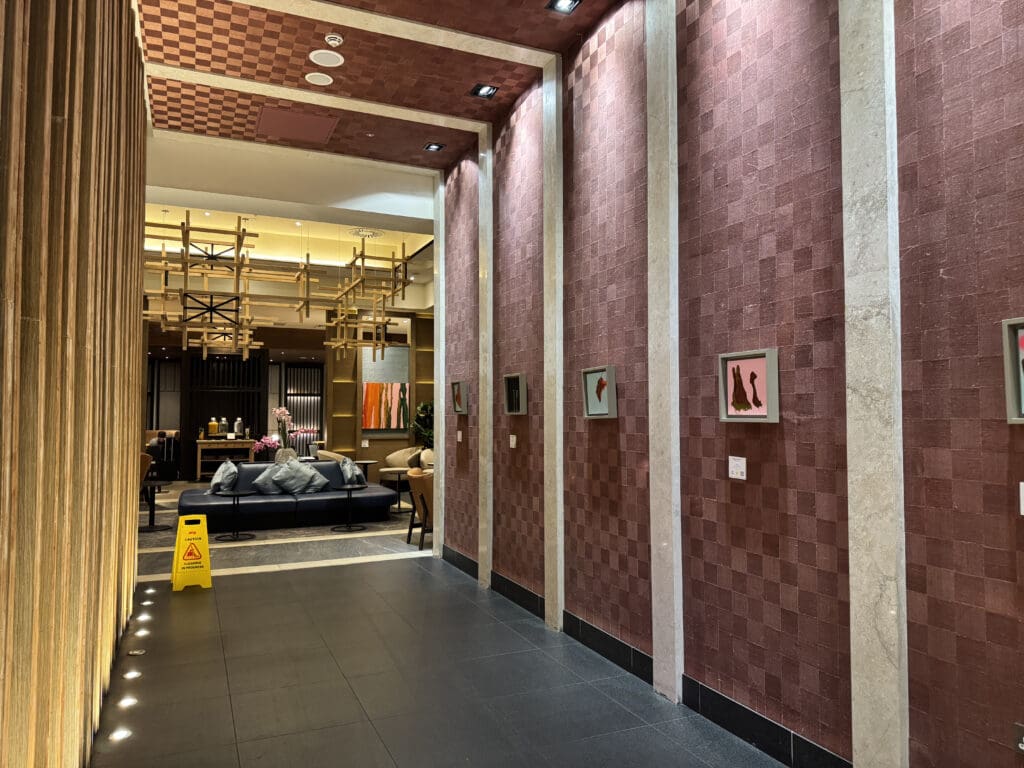 a hallway with a couch and pictures on the wall