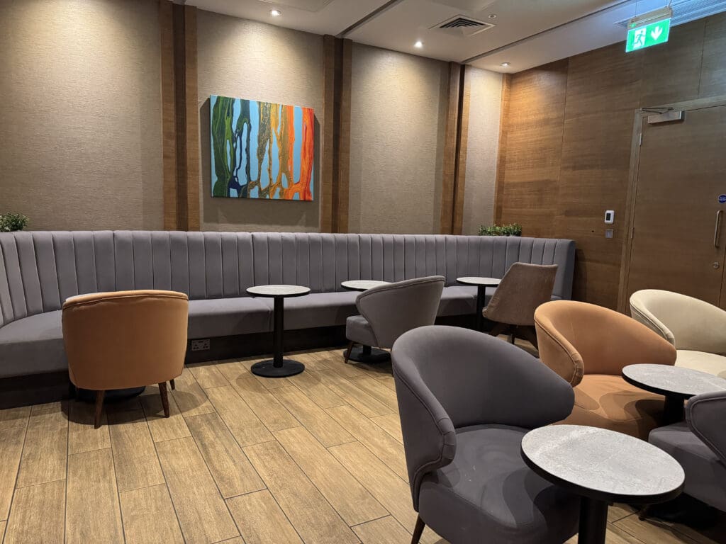 a room with a couch and chairs