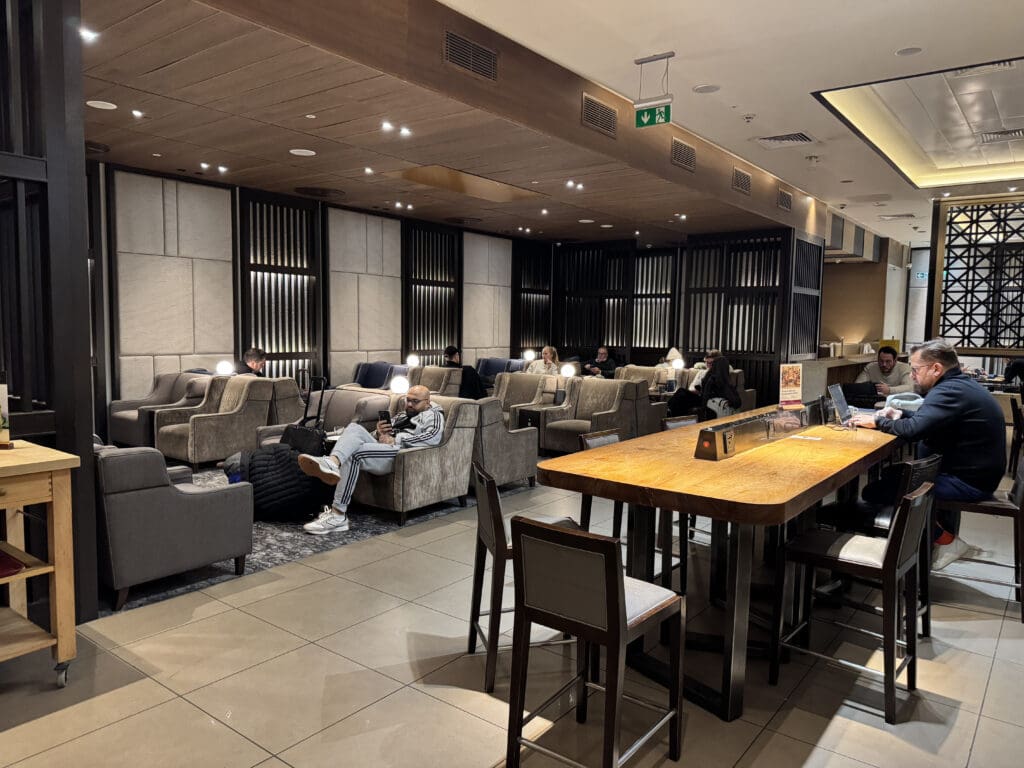 a group of people sitting in a room with chairs and tables