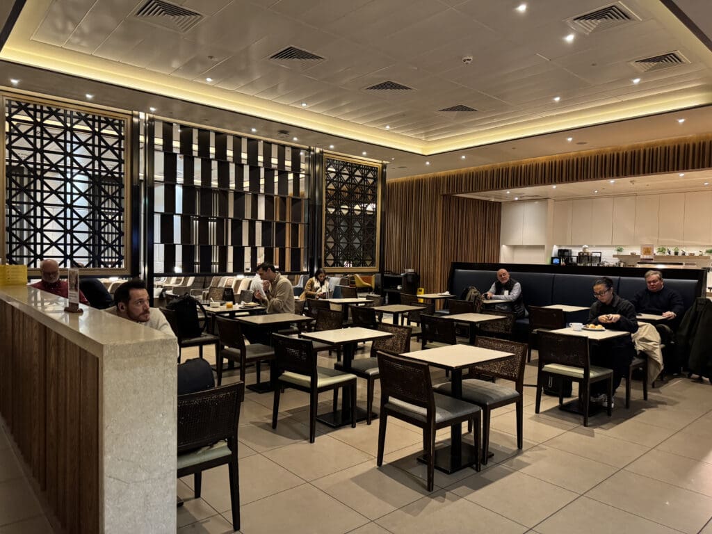 a group of people sitting at tables in a restaurant