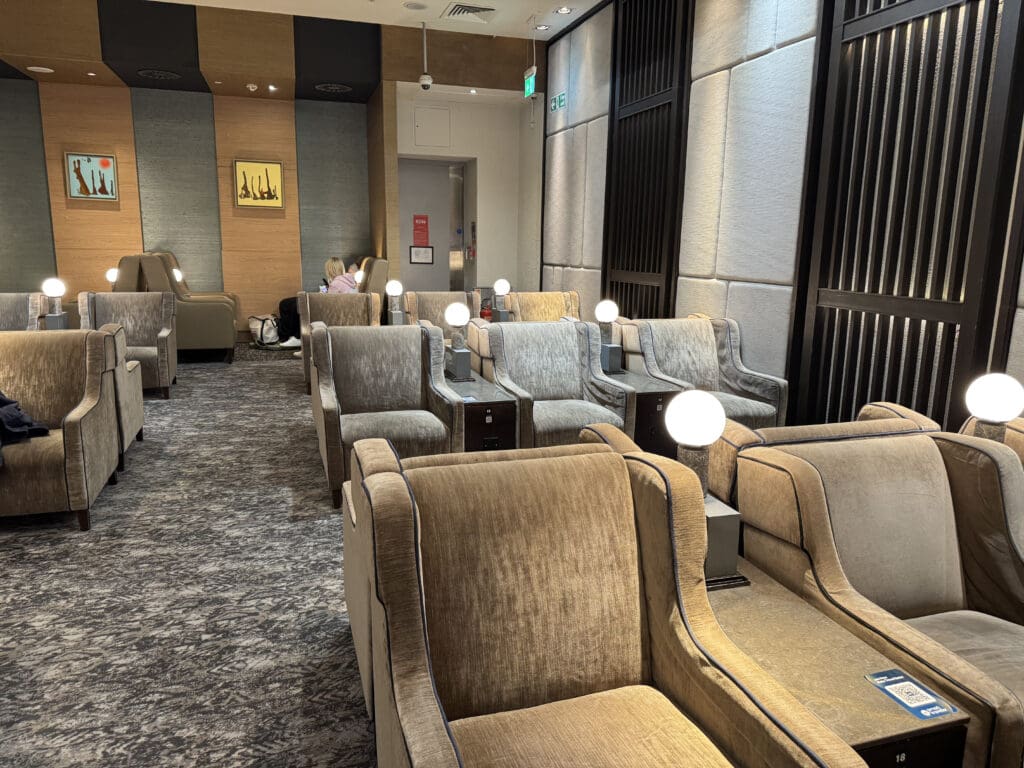 a room with chairs and a lamp