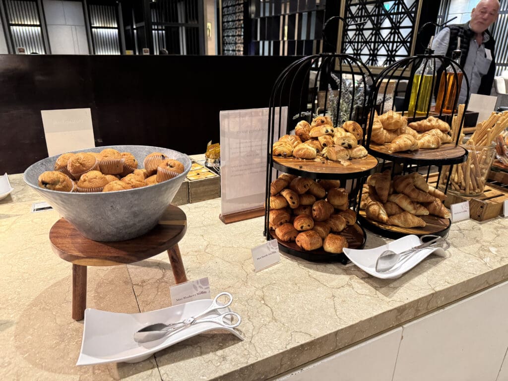 a buffet table with pastries and bread