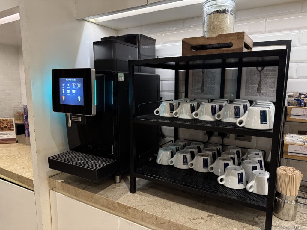 a coffee machine and coffee cups on shelves