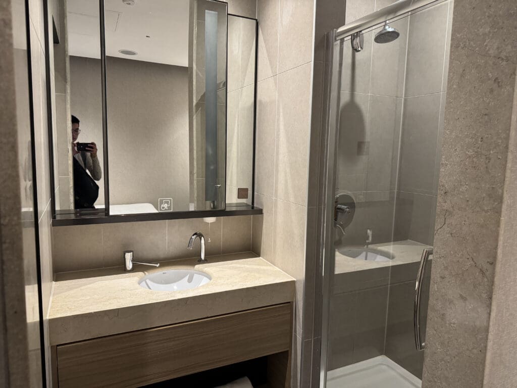 a bathroom with a shower and sink