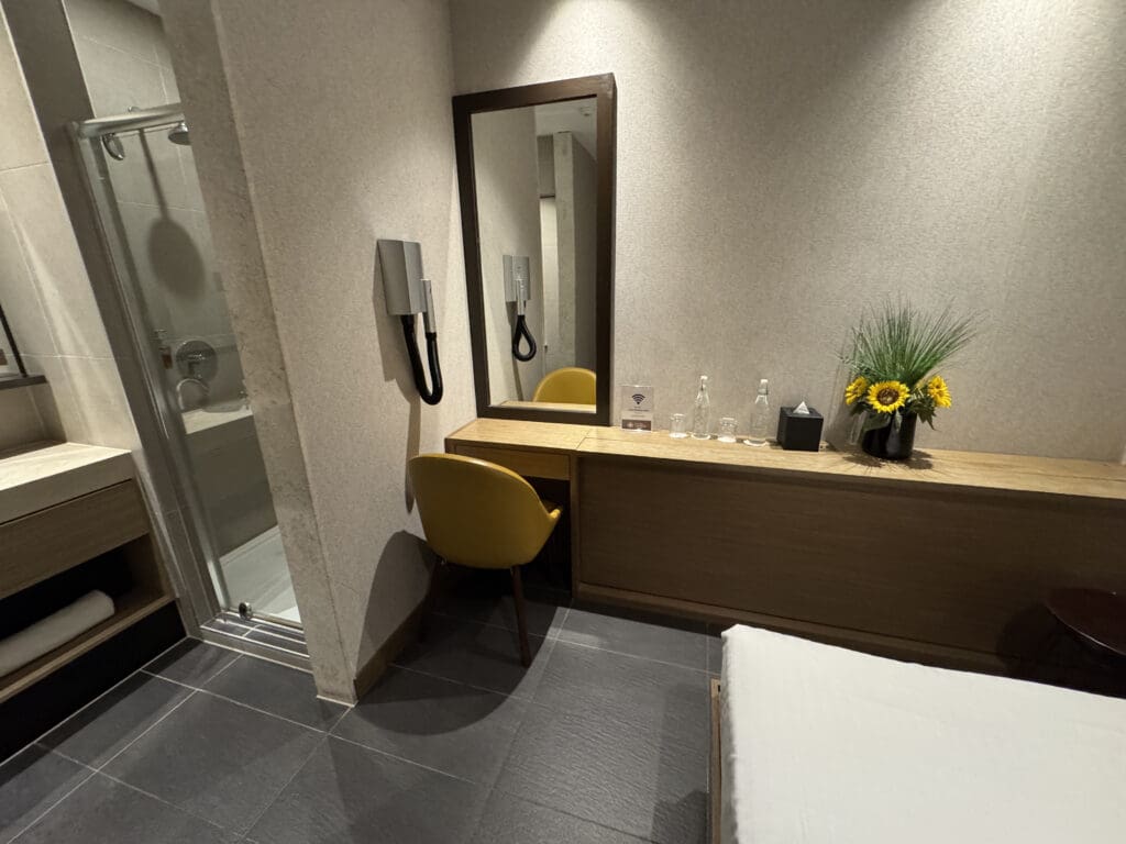 a room with a mirror and a chair