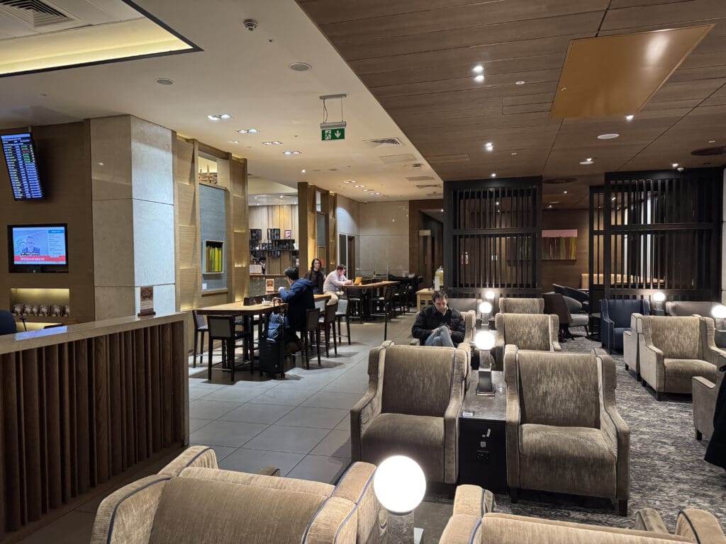 a room with a group of people sitting at tables and chairs