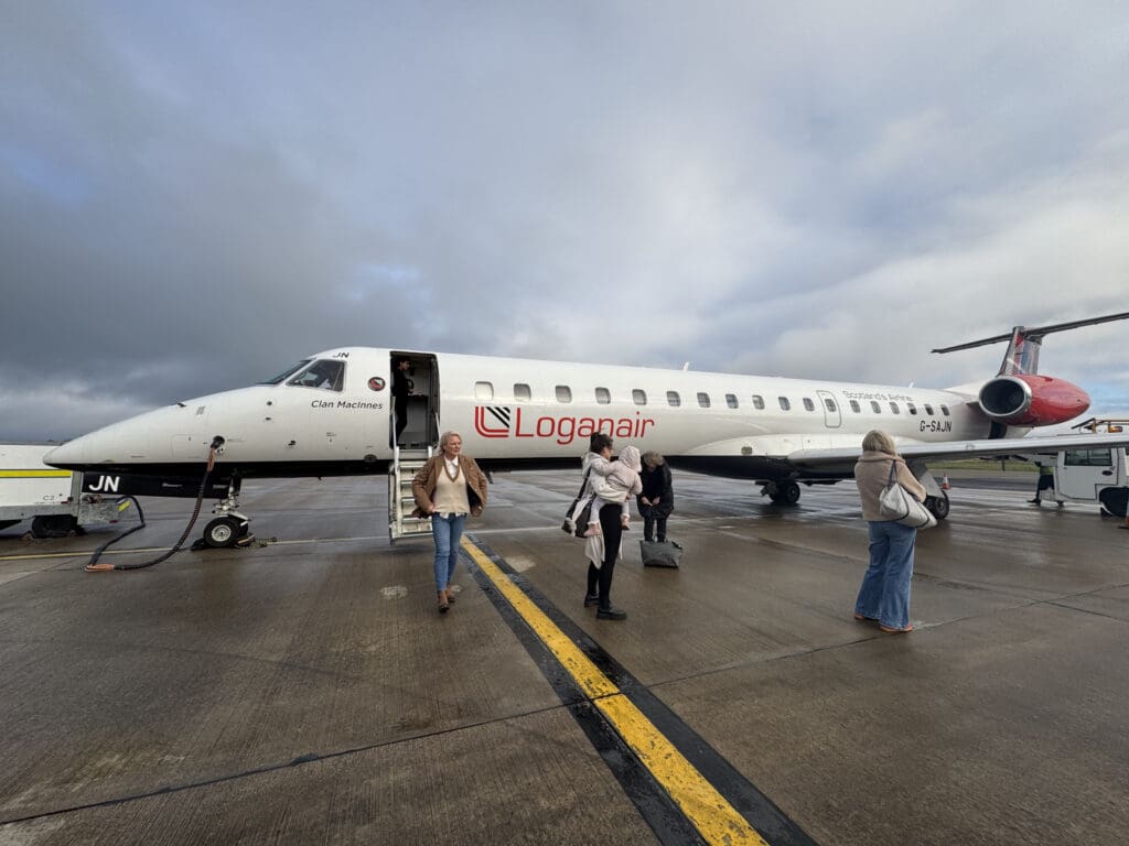 people standing next to a plane