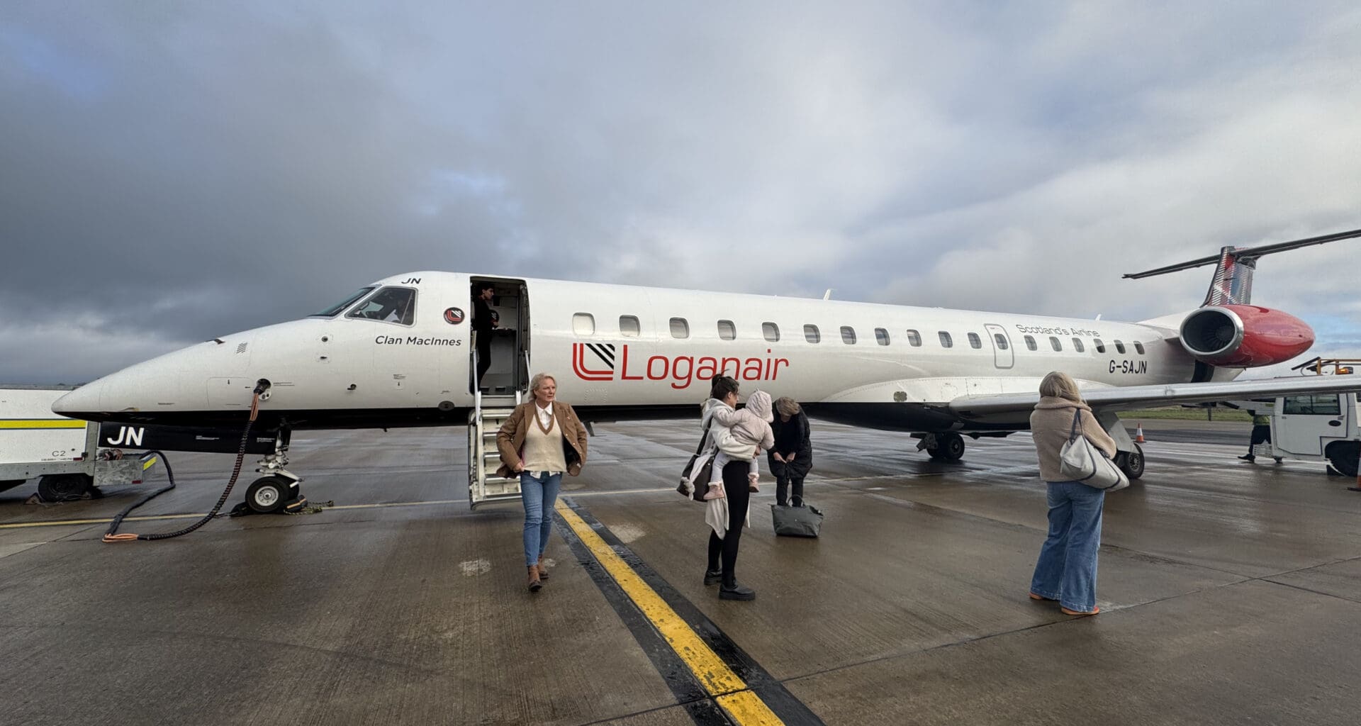 people standing next to a plane