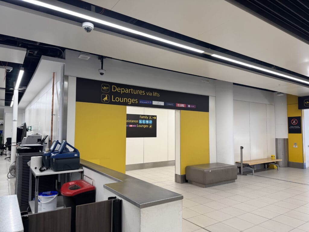 a hallway with a sign and a bench