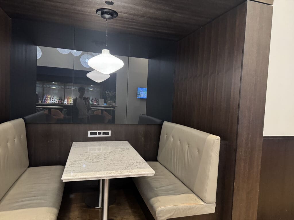 a booth with a table and a mirror