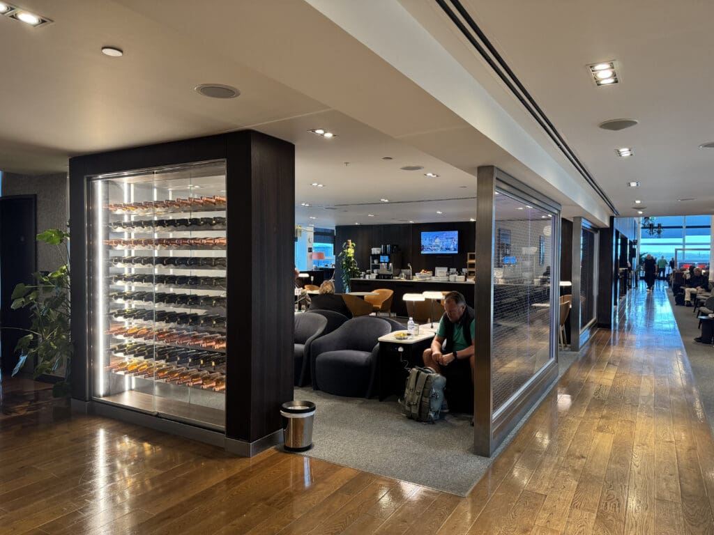 a man sitting in a chair in a room with a glass display case