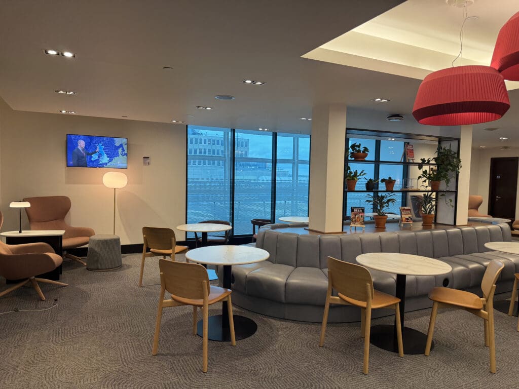 a room with a couch and chairs