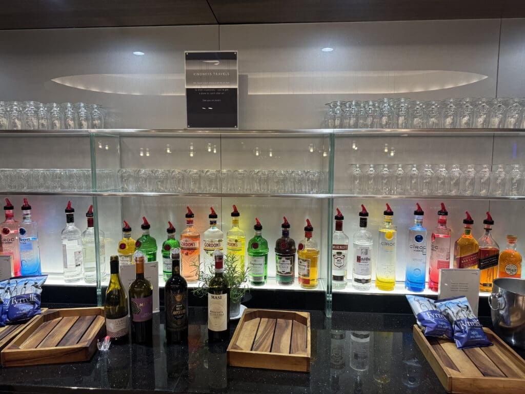 a shelf with bottles of alcohol and glasses