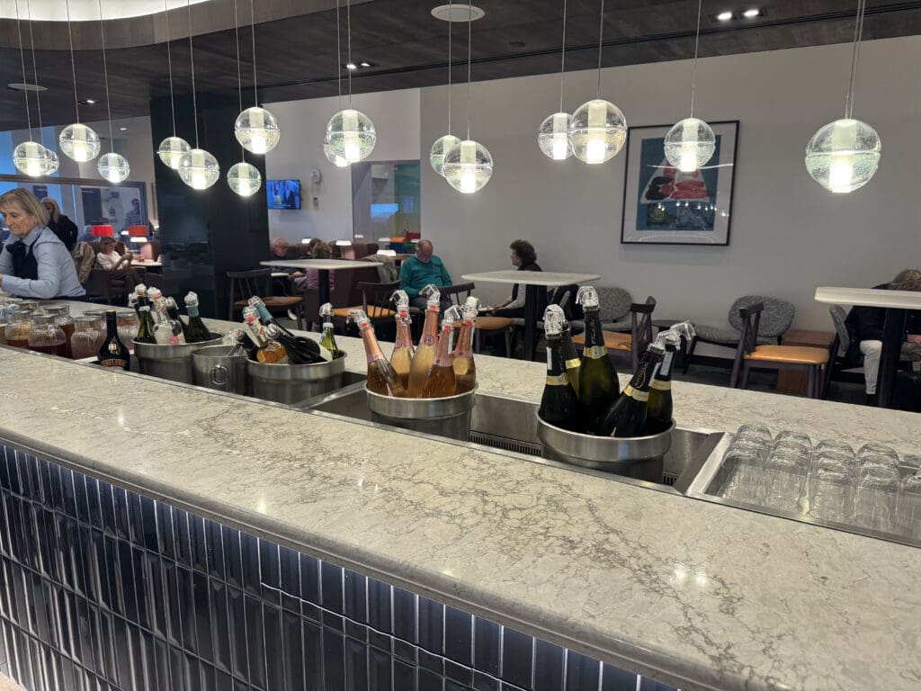 a group of bottles of champagne in buckets on a counter